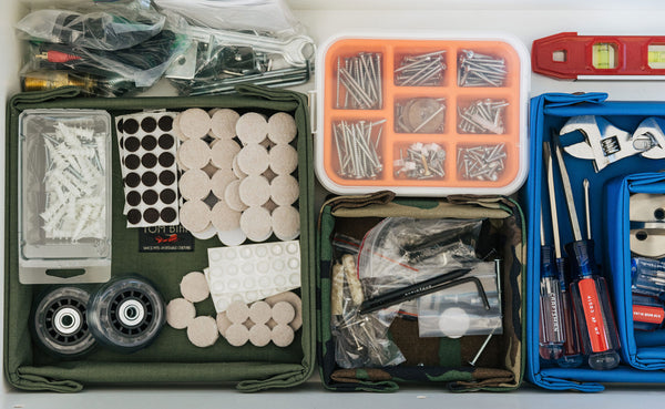 Various tools and home supplies organized in four Tray Biens.